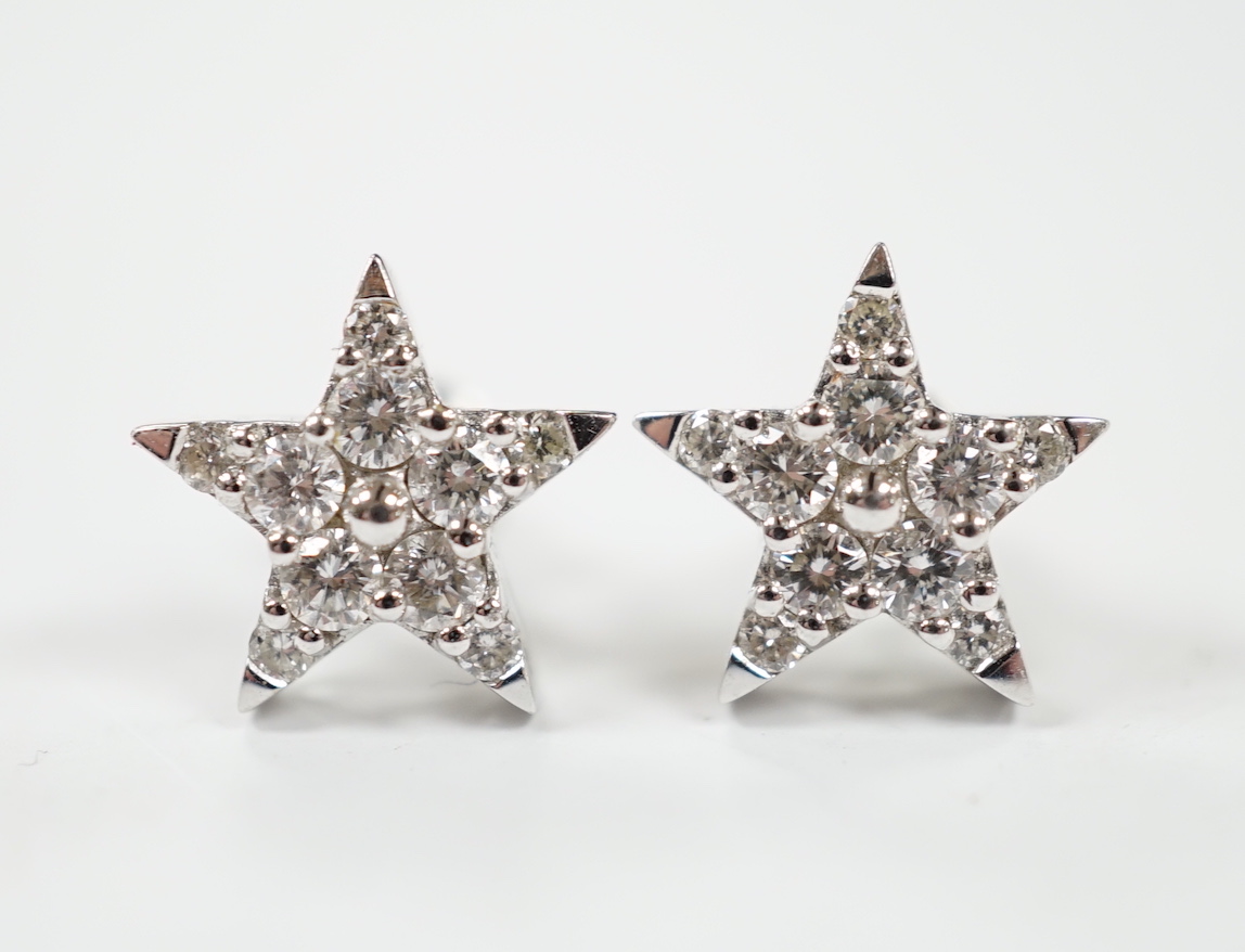 A modern pair of 18ct white gold and diamond chip star shaped ear studs, 10mm, gross weight 2.2 grams.
